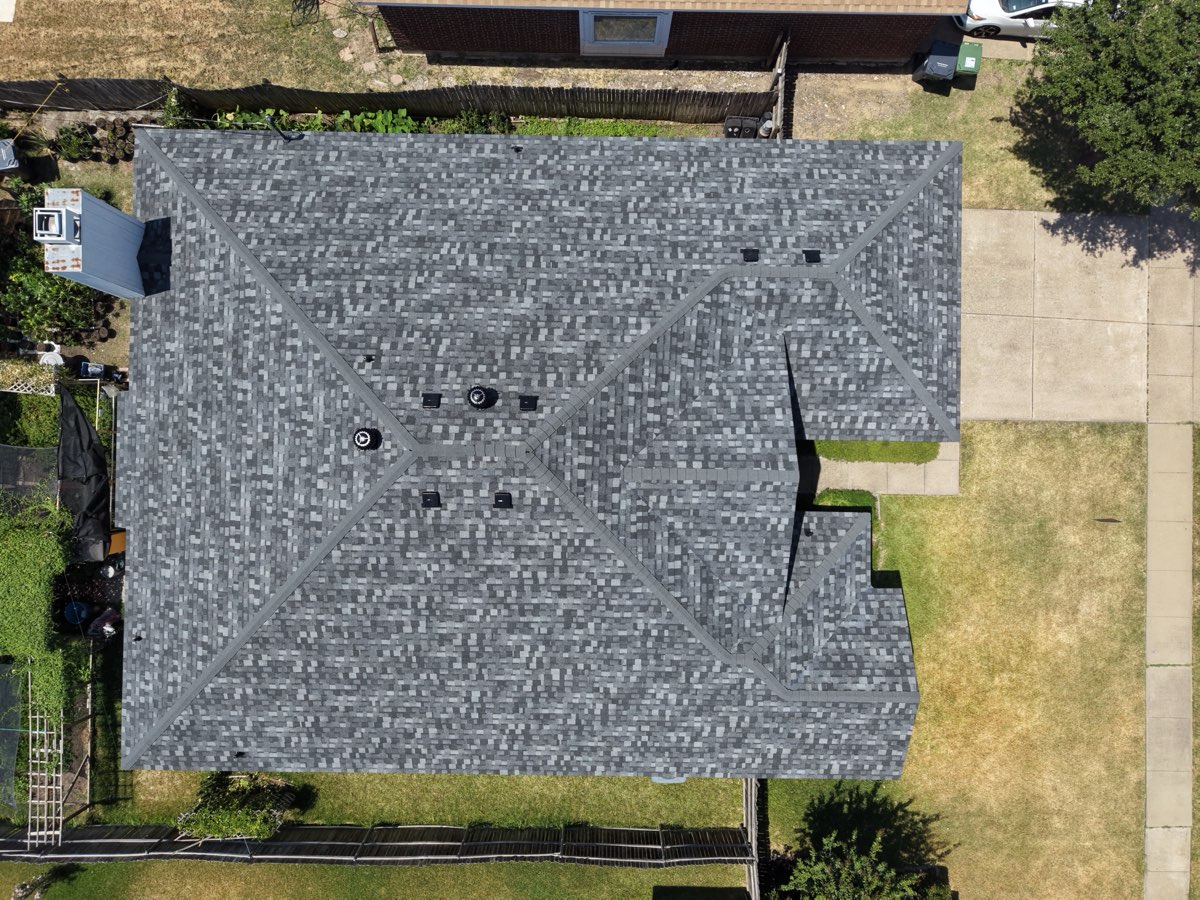 After: finished gray shingle roof replacement by Lonestar Roofing, aerial drone view of a DFW home