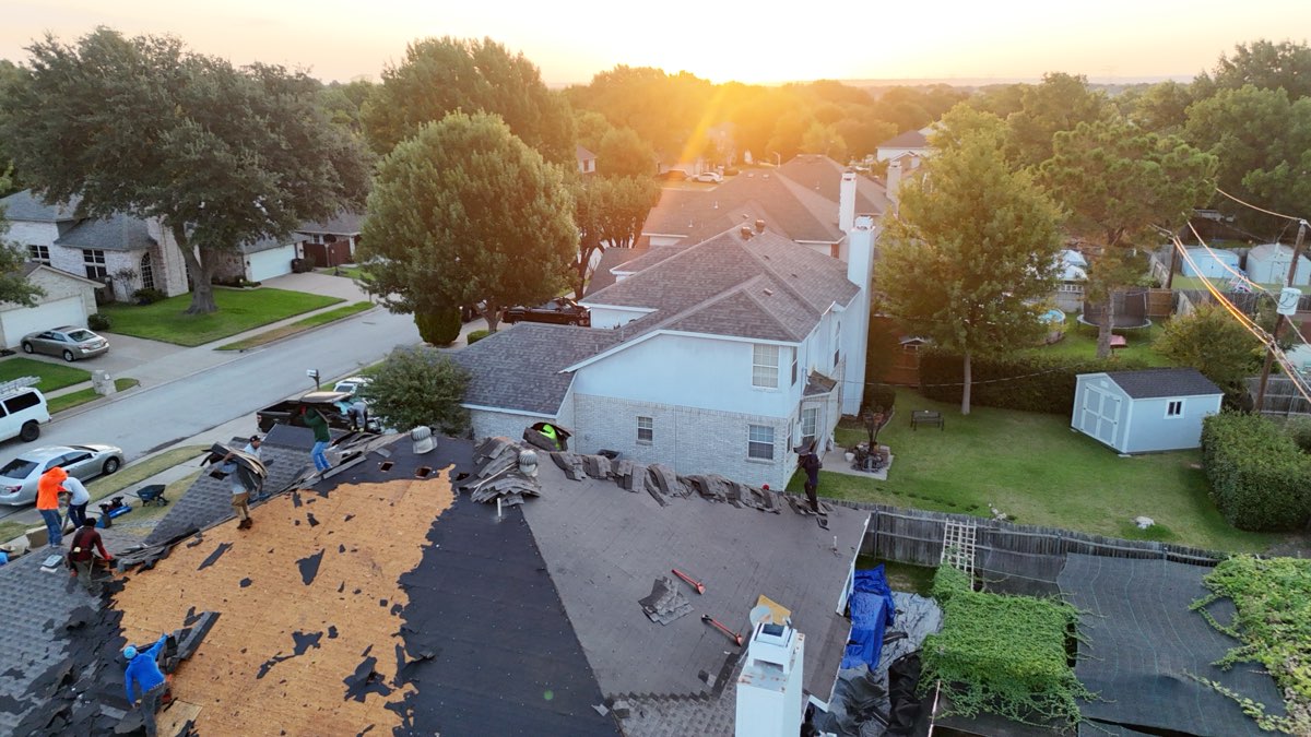 Before: DFW roof mid tear-off with bare decking exposed, ahead of a Lonestar Roofing shingle replacement